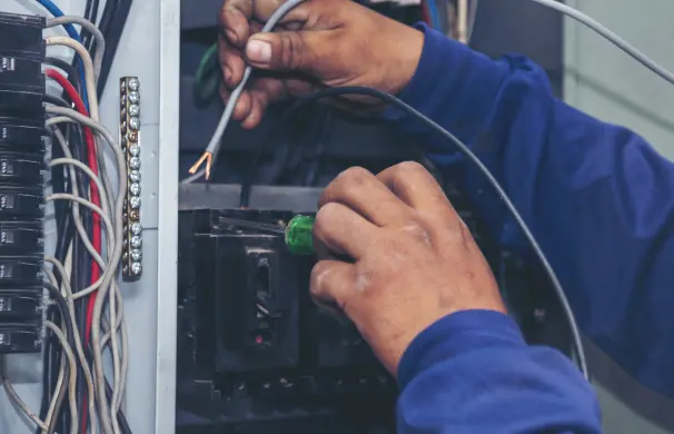 1745291745946_1745228917039_GettyImages-894471 1 (10) Electrician working on circuit breaker panel.