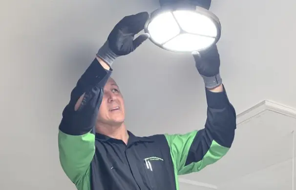 1745291745946_1745228917039_GettyImages-894471 1 (11) Electrician installing a ceiling light fixture.