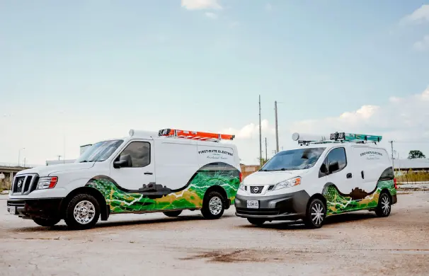 1745291745946_1745228917039_GettyImages-894471 1 (3) Two decorated utility vans parked outdoors.