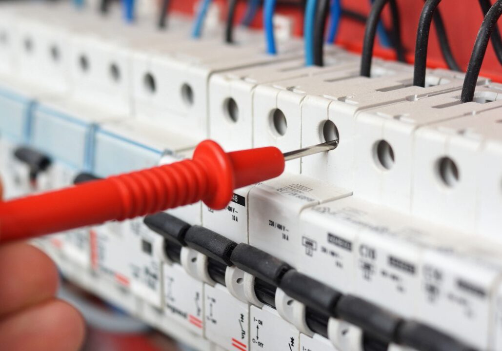 Testing electrical circuit with red probe.